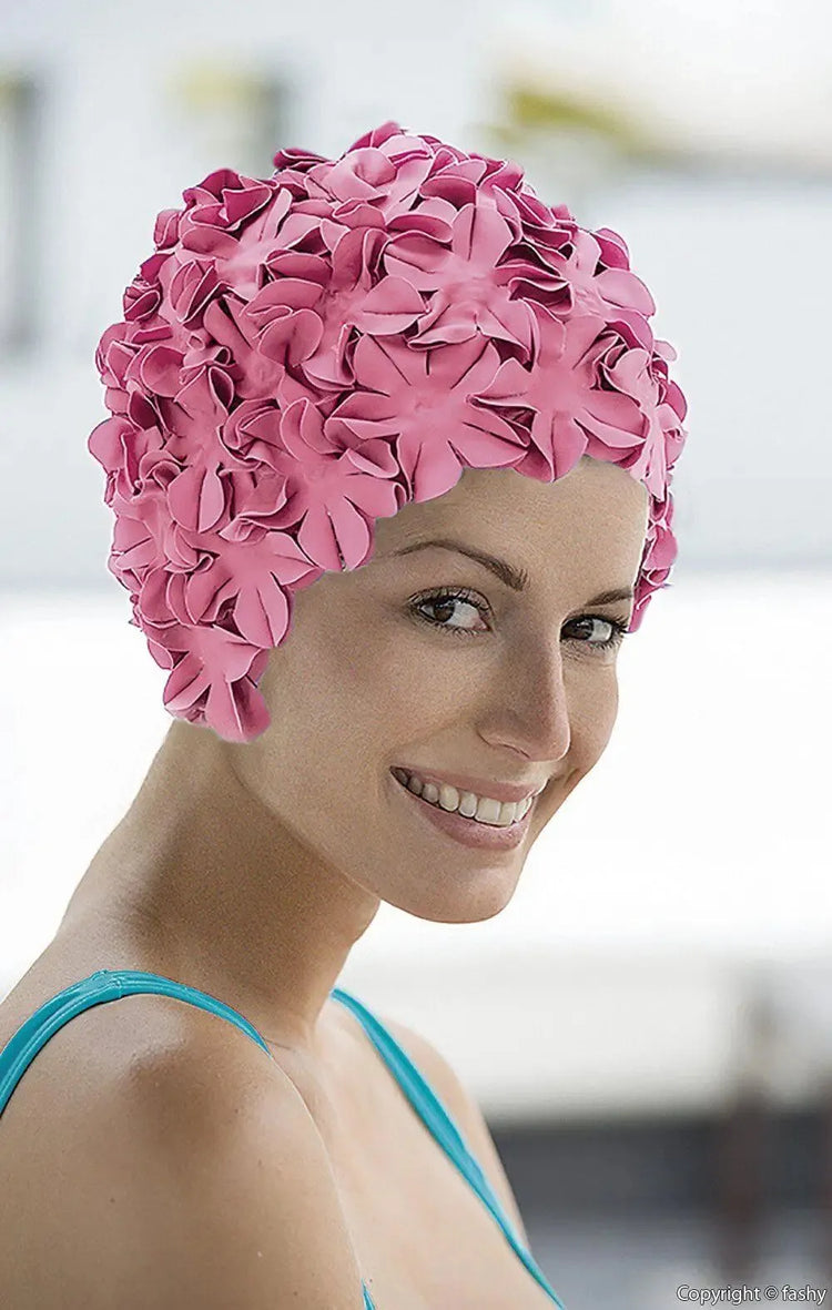 a women wearing a pink flower swimming hat